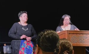 Amanda Wanotch and Chelsa Reil speak on stage.